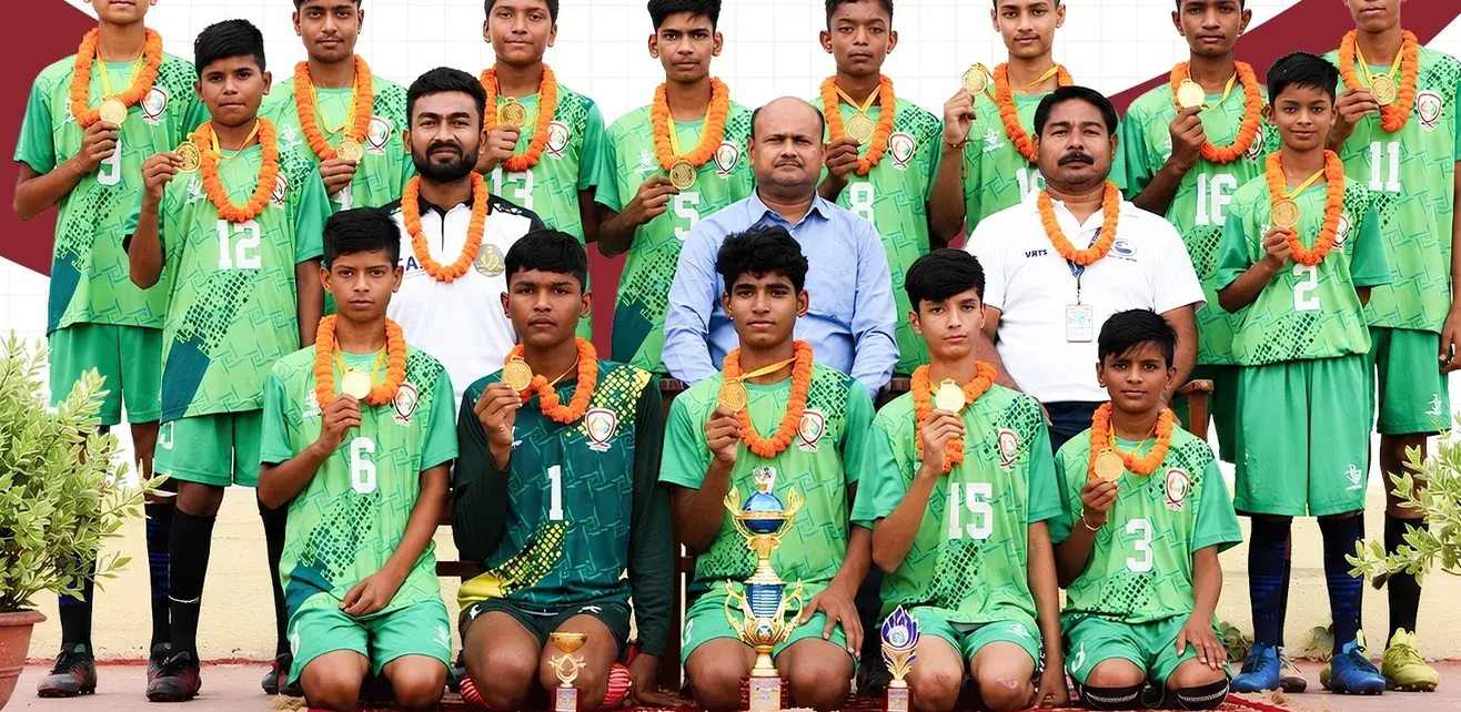 The Doon Public School Under-14 football team with their trophy, coach and teachers