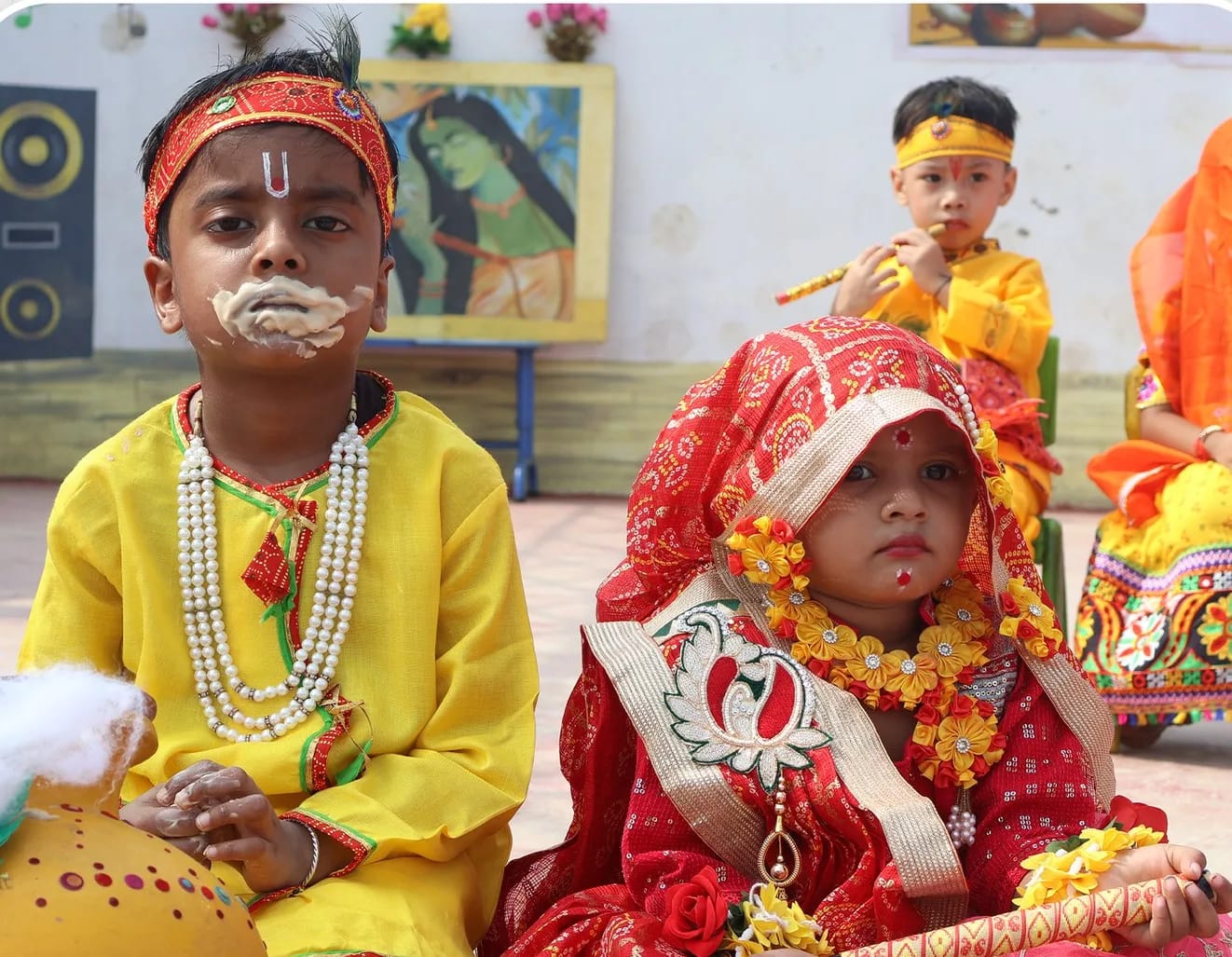 A young student dressed as Krishna and another as Radha at the Janmashtami celebration