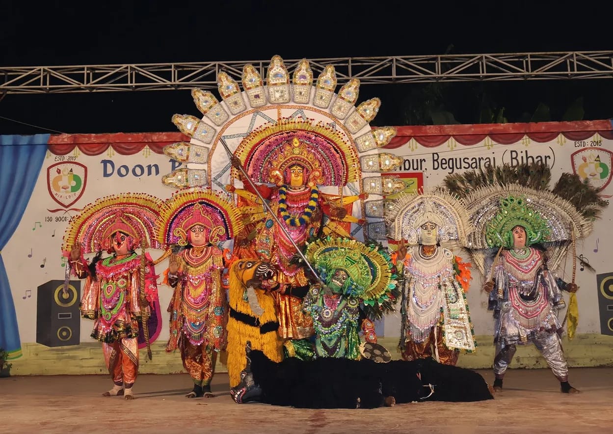 Purulia Chhau dancers in masks and costumes performing on the Doon Public School stage