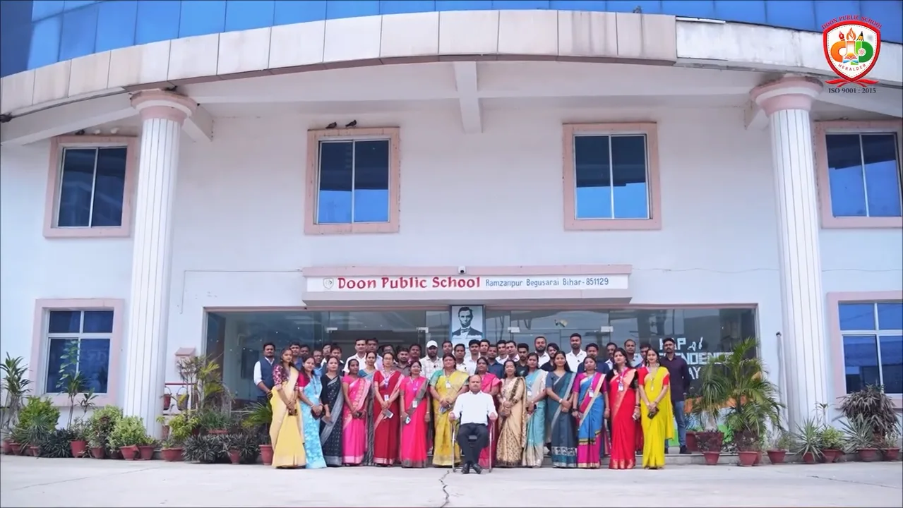 The teachers of Doon Public School together in front of the main building