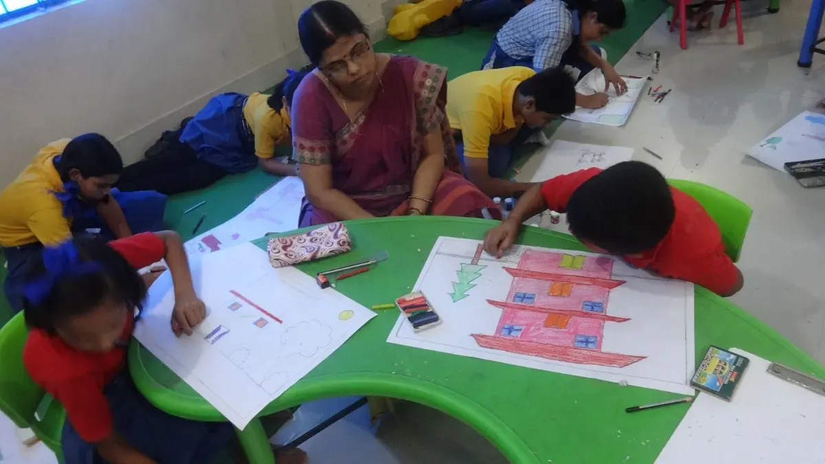 Students painting at their tables during a painting competition