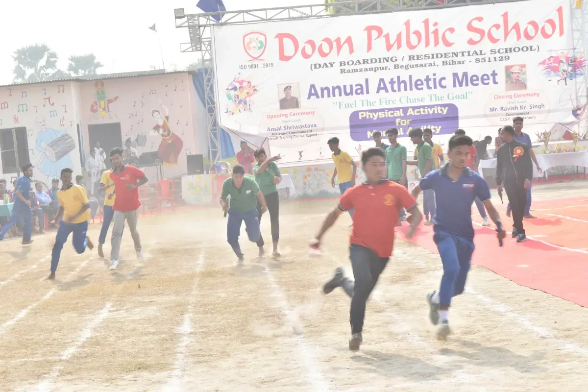 Students sprinting down the track at the annual athletic meet